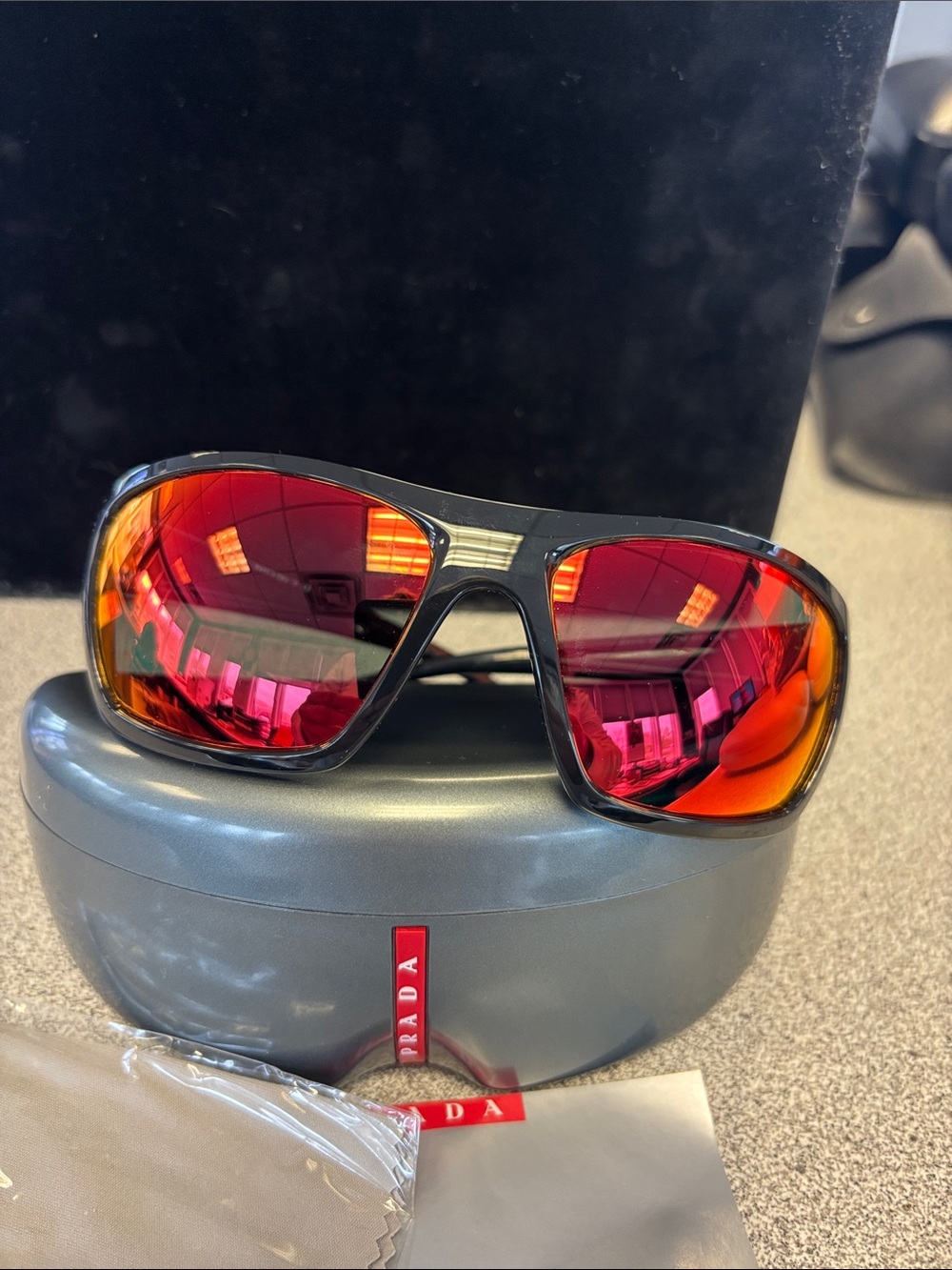 Prada Black Sunglasses with Red-Orange Mirrored Lenses
